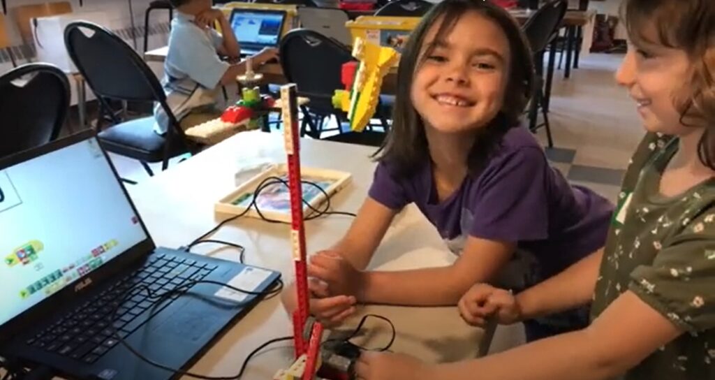 Young camper building a LEGO robot